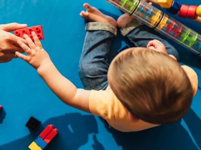 happy-baby-playing-with-toy-blocks-picture-id817588604